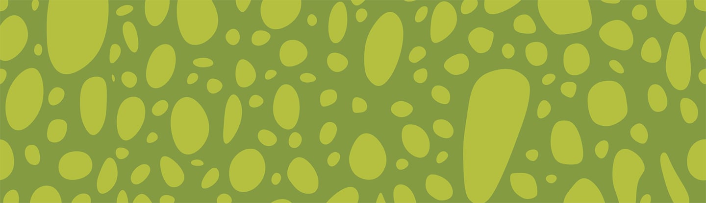 A green pattern with scattered oval and rounded spots of varying sizes
